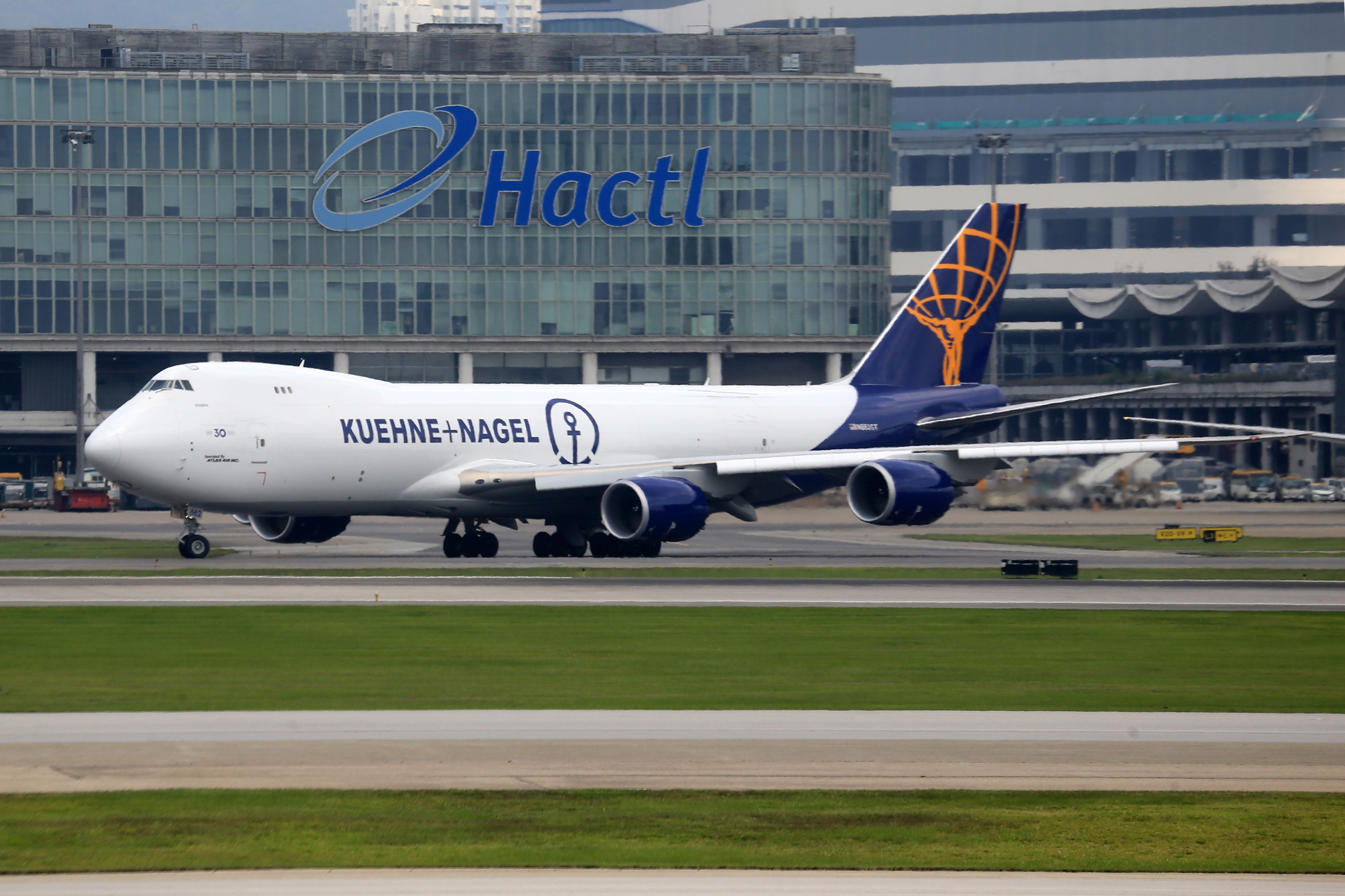 Commercial cargo airplane on runway at Hactl terminal, ready for departure.