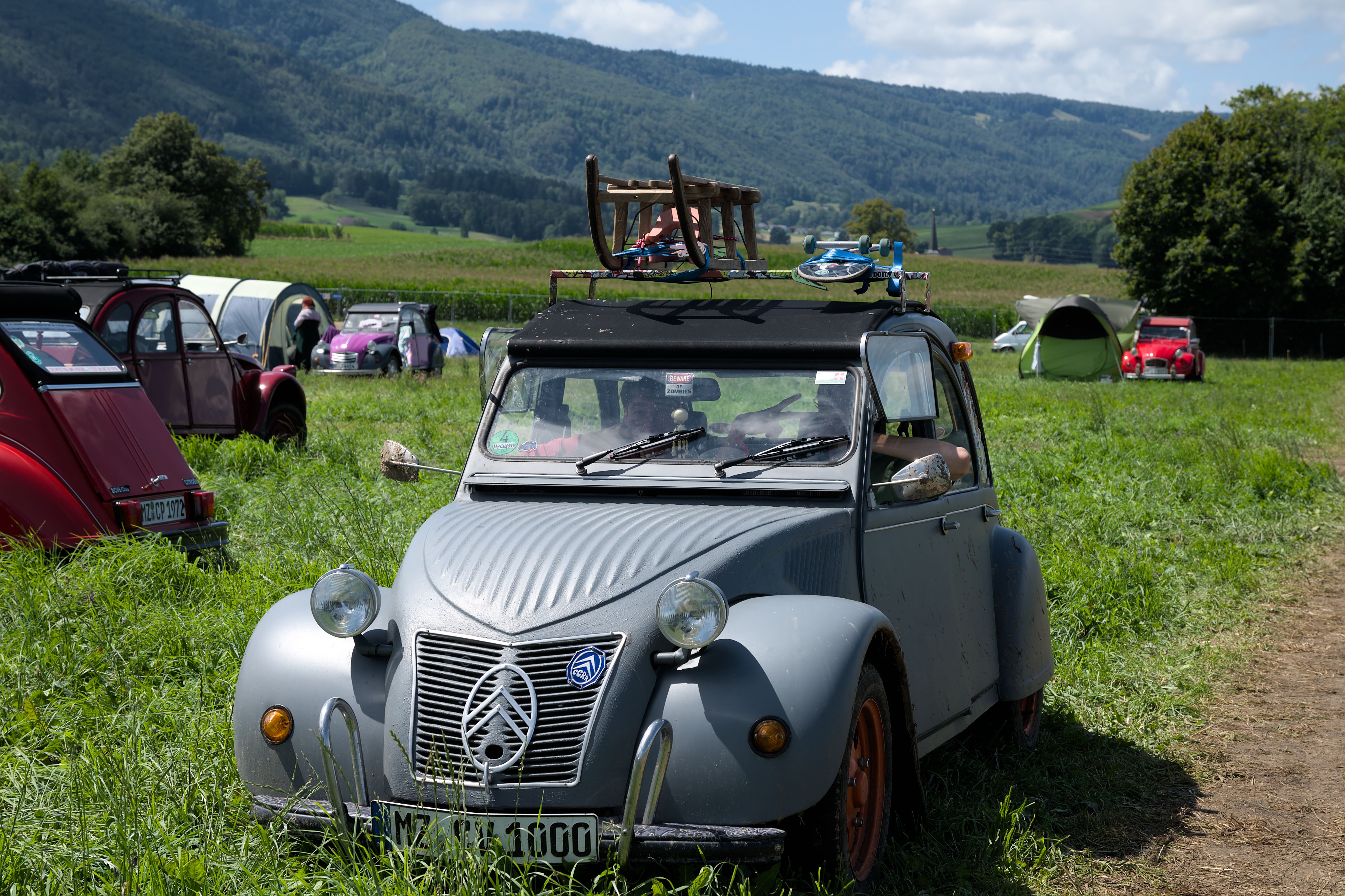 Classic Citroën 2CV parked in a rural Delémont setting