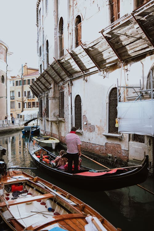 People in Gondola at a Canal in Venice, Italy