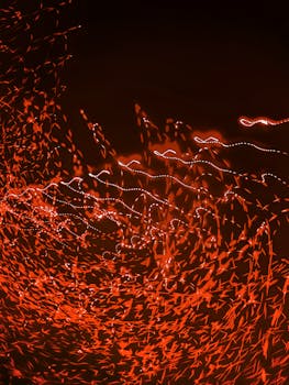 Abstract red light trails creating an energetic and dynamic pattern, perfect for backgrounds and designs.