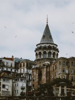 View of the iconic Galata Tower amidst urban architecture in Istanbul.