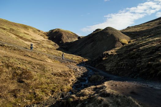 Explore a picturesque hiking trail with rolling hills near Reykjavík, Iceland.