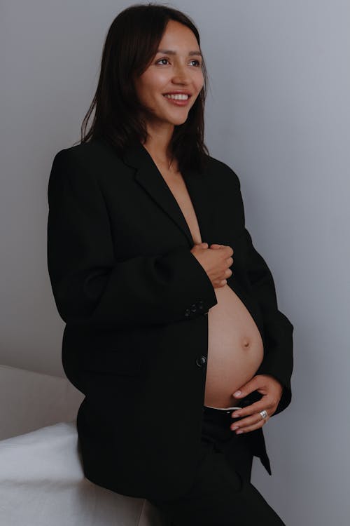 Pregnant Brunette Woman Posing in Black Blazer and Pants