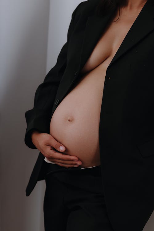 Pregnant Woman with her Hand on a Belly 