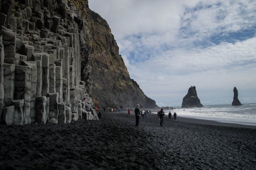 Reynisfjara black sand beach with basalt columns and sea stacks near Reykjavík, Iceland.