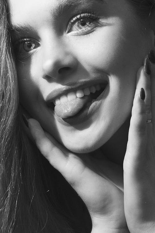 Woman Sticking Out her Tongue in Grayscale
