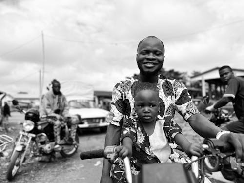 Man with his Son Riding a Motorcycle 