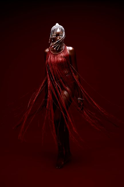 Elegant studio shoot featuring a woman in a contemporary fringe dress and head chain.