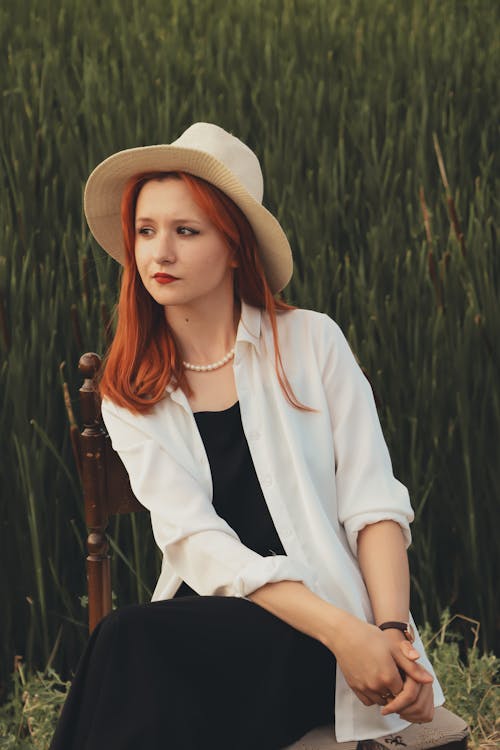 Red Haired Woman Posing in White Shirt and Straw Hat 