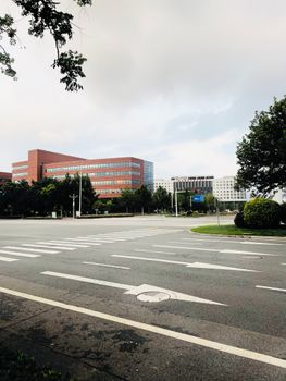 Wide view of a city intersection featuring modern office buildings and crosswalks, ideal for urban themes.