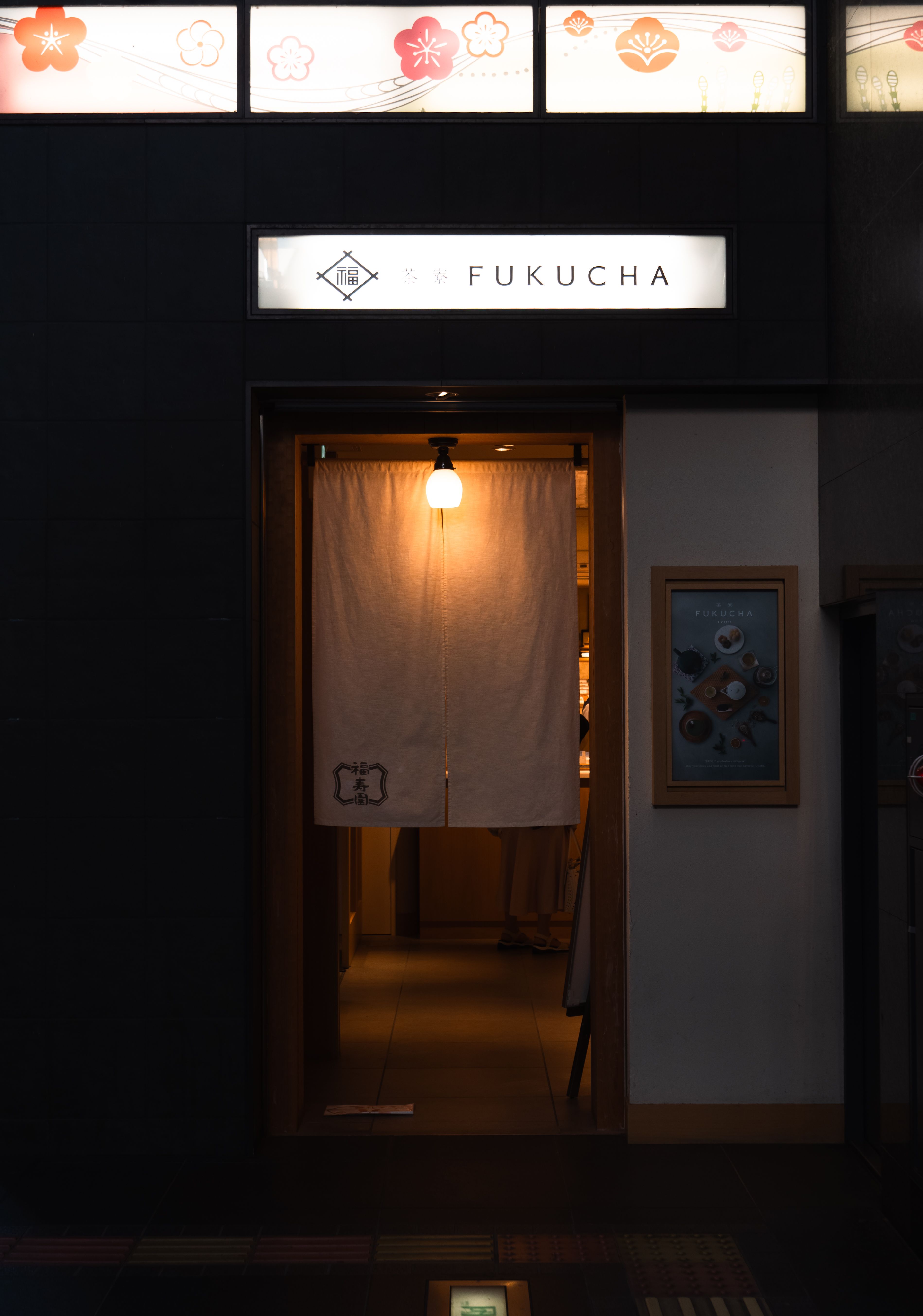 Warmly lit entrance with Japanese curtain in Kyoto, Japan