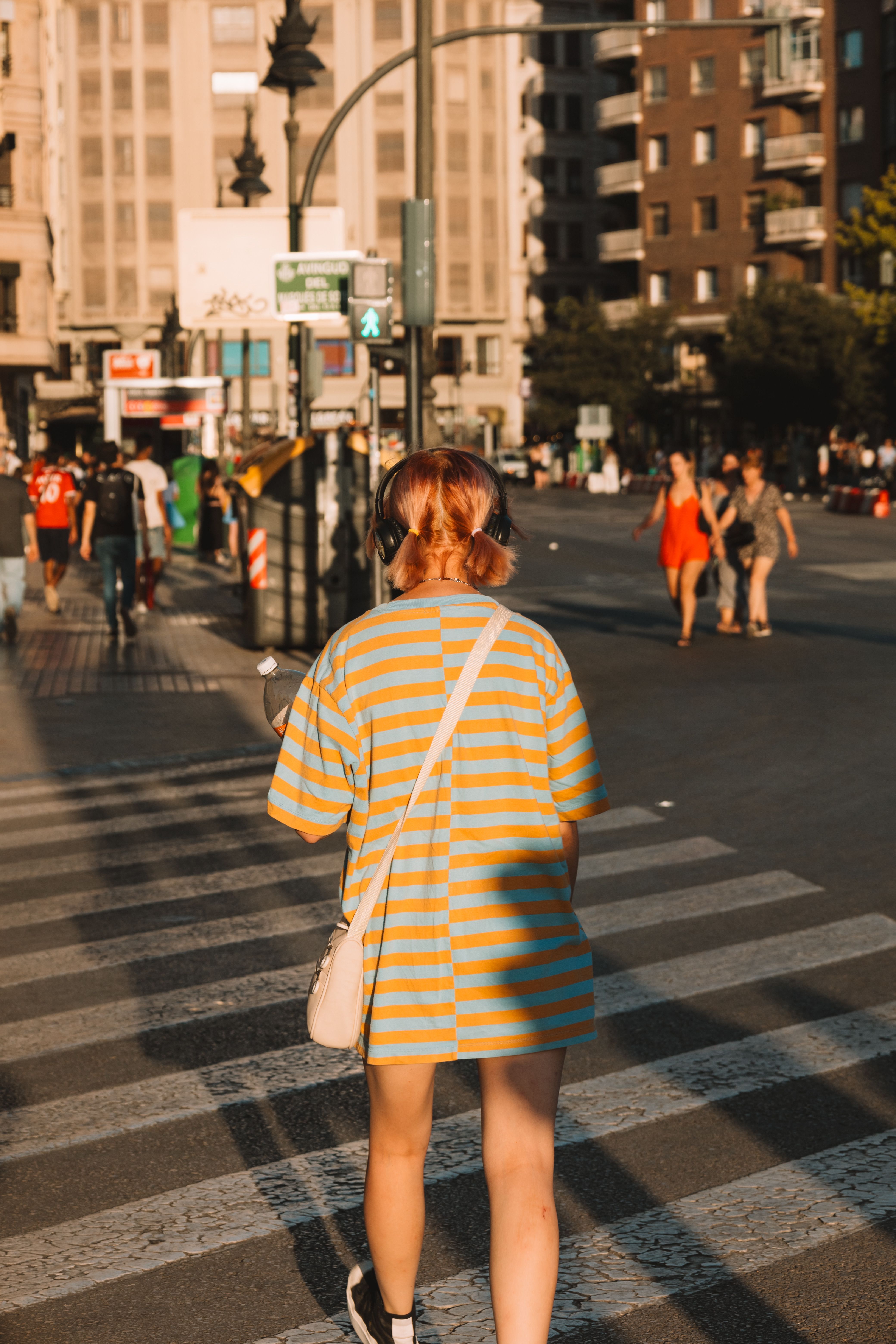 Back View of a Woman with a Smartphone Standing at a Crosswalk in City ...