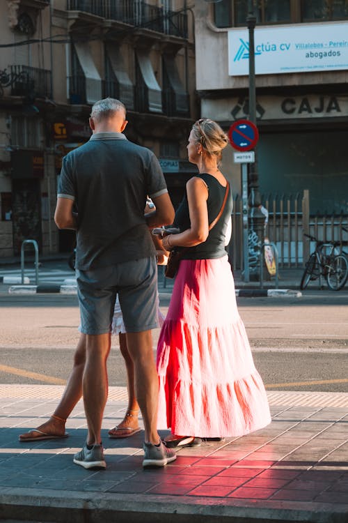 Candid Picture of a Group of People Standing on the Sidewalk 