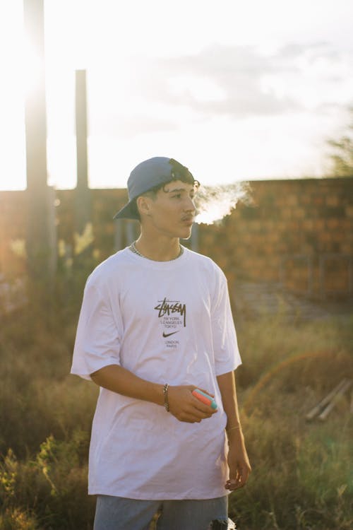 Teenager in a T-Shirt and a Baseball Cap