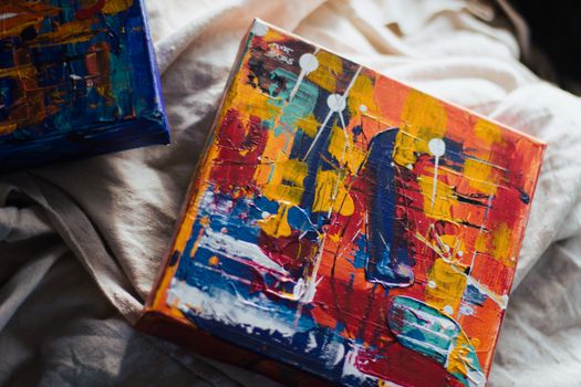 Colorful abstract oil painting with bold brushstrokes on vibrant canvas surface.