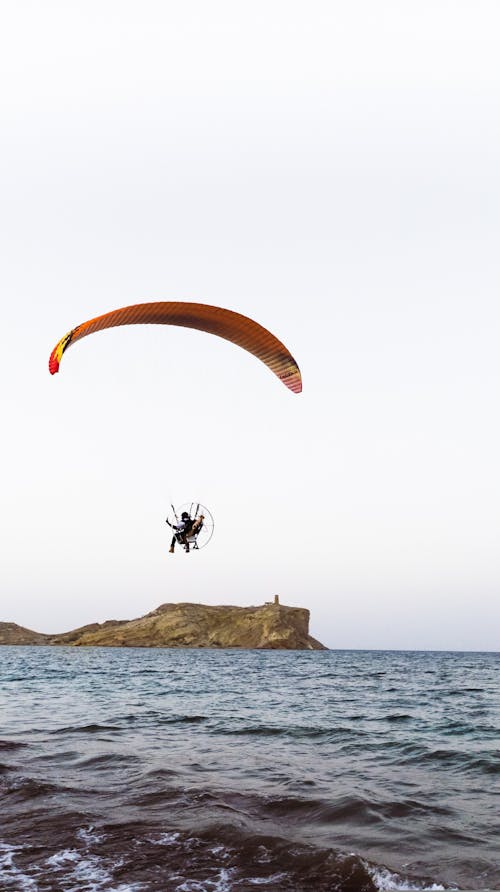 People Parachuting on Sea Coast