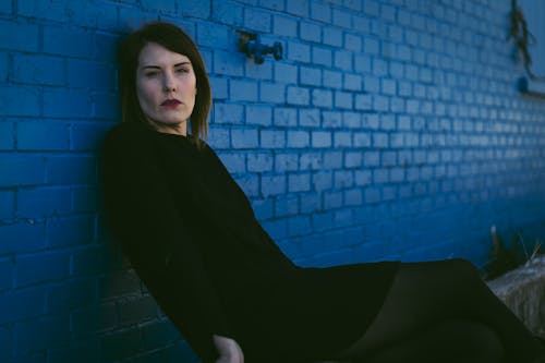Woman Sitting in Black Clothes