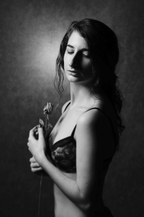 Free Woman in Floral Bra Holding Rose Stock Photo