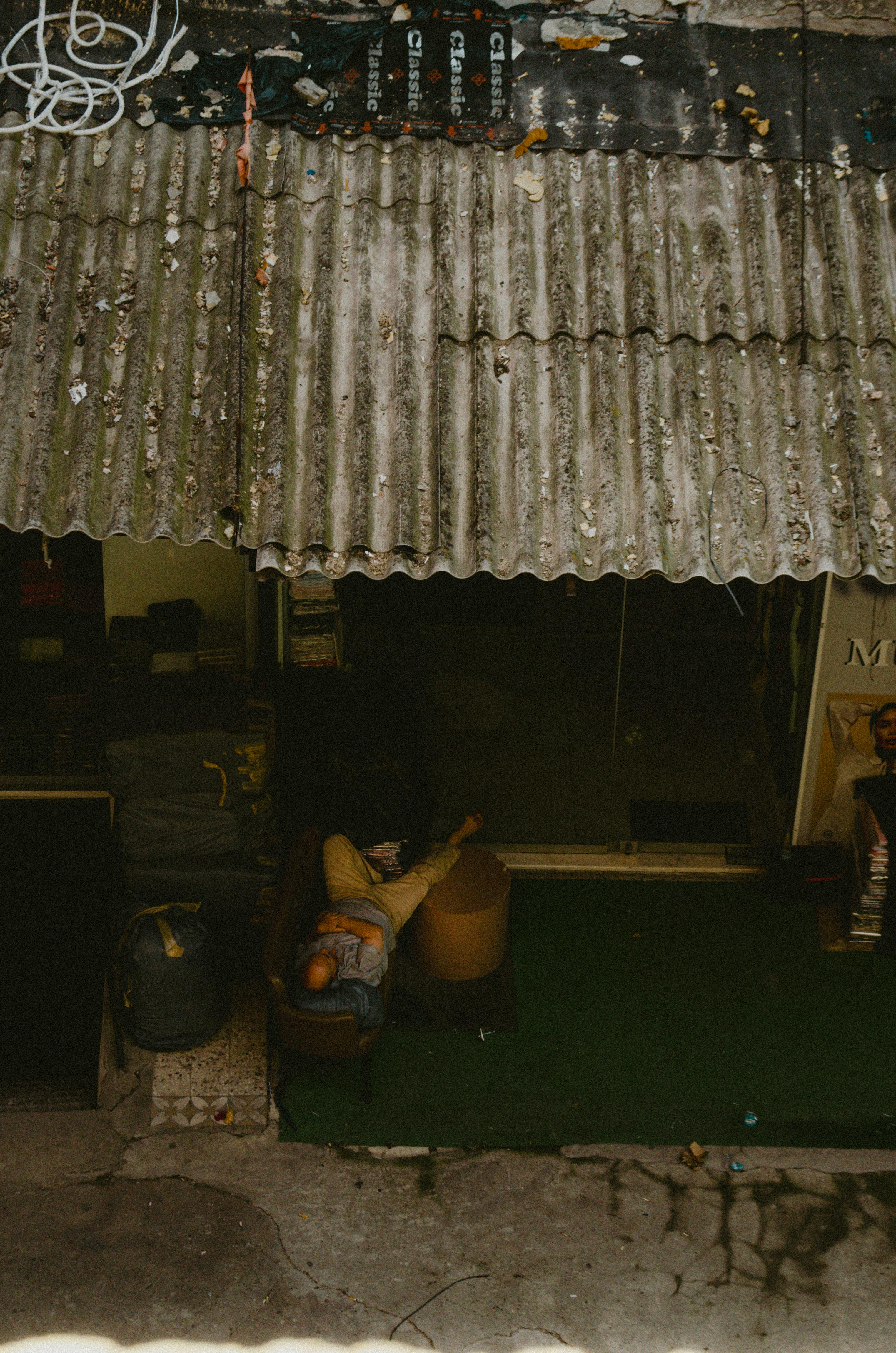 Man Lying Down under House Roof · Free Stock Photo