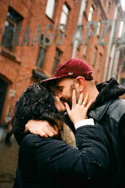 Couple Kissing in Snowfall