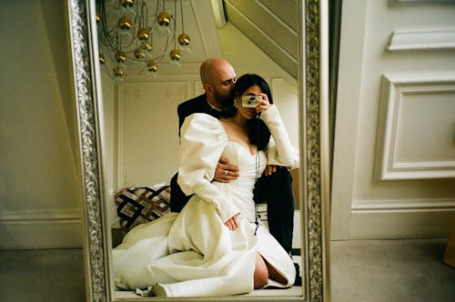 Newlyweds Hugging and Taking Pictures in Mirror