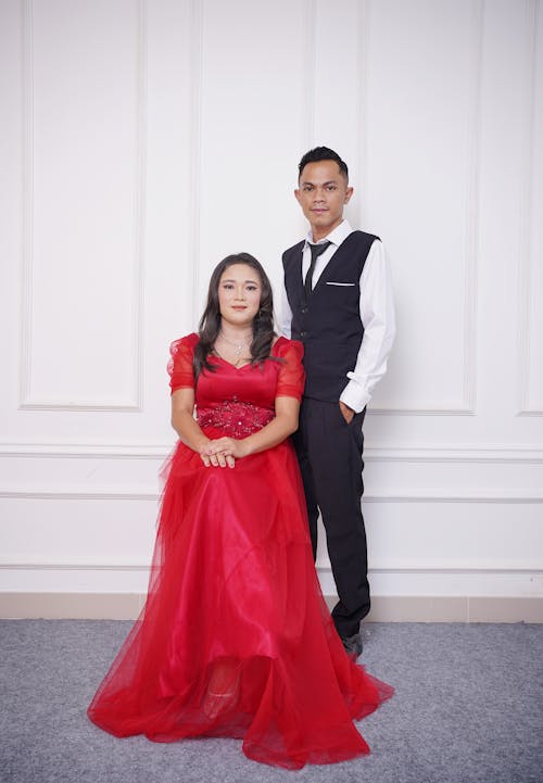 Woman in Red Dress and Man in Shirt with Vest