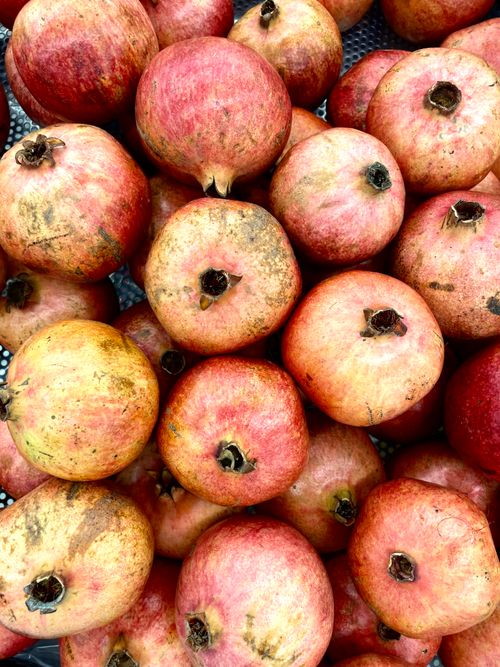 Free A vibrant collection of pomegranates in a close-up shot, showcasing their texture and color. Stock Photo