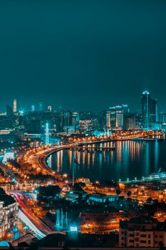 Captivating cityscape of Baku at night with illuminated skyline and waterfront.