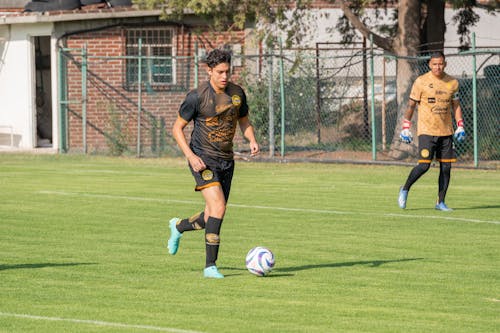 Men Playing Soccer on a Field 