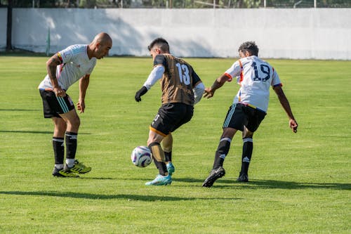 Men Playing Soccer on a Field 