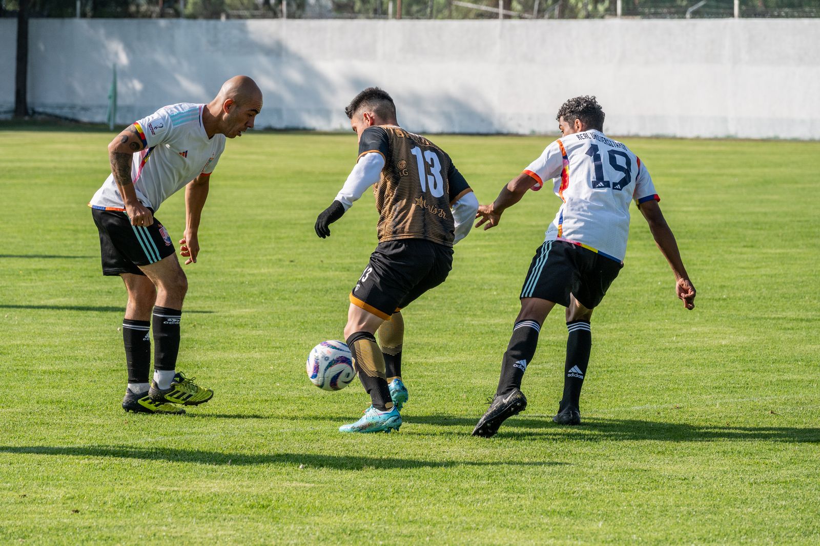 Players contesting the ball in a league fixture