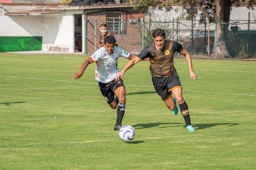 Men Playing Soccer on a Field 