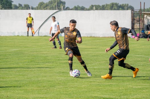 Soccer players in action during a daytime match, displaying teamwork and strategy.