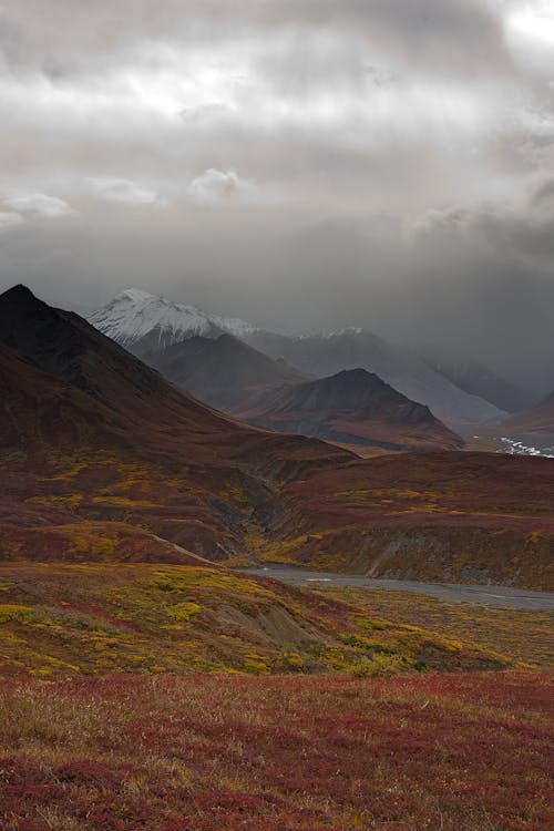 View of Mountains under a Cloudy Sky 