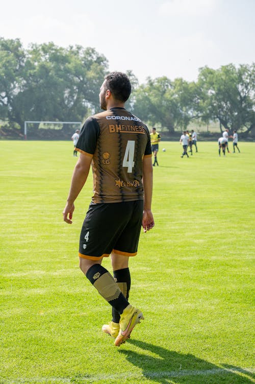 Man in Soccer Player Uniform Walking on a Pitch