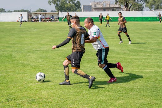 Players in action during a competitive soccer game on a green field, showcasing intense athletic performance.