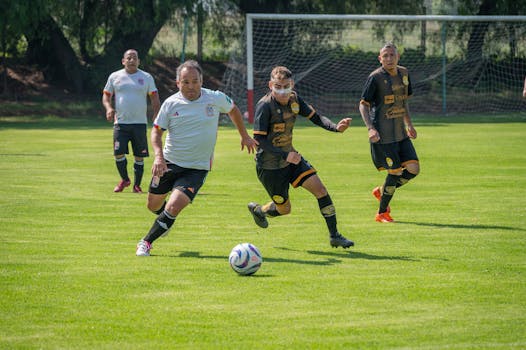 Action-packed amateur soccer match scene with adult players in sportswear on a sunny day.