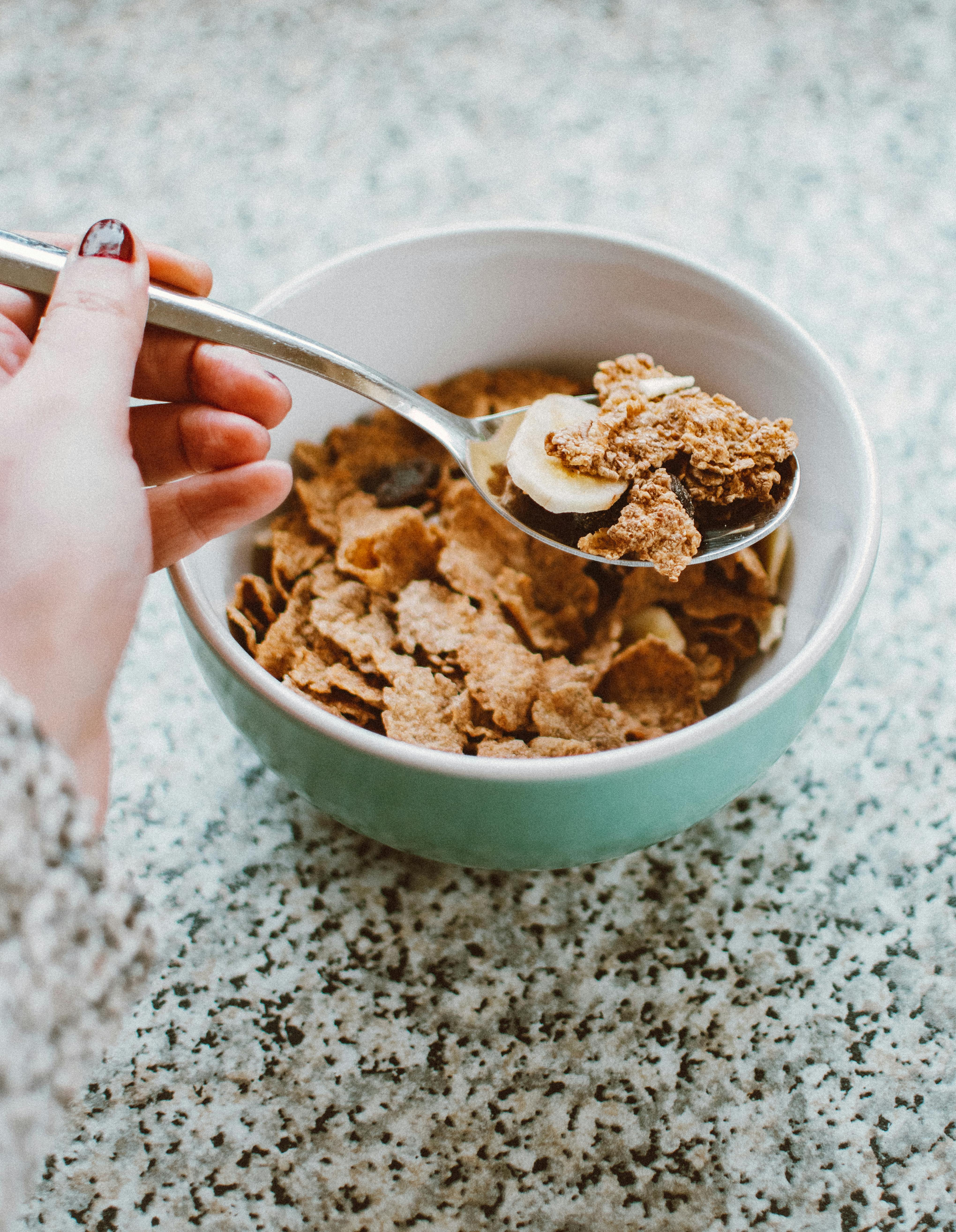 Free Close-up of a bowl with cereals and banana slices, perfect for a healthy breakfast. Stock Photo