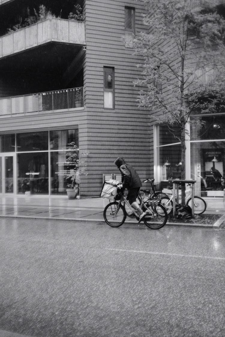 Man Riding Bike In Rain