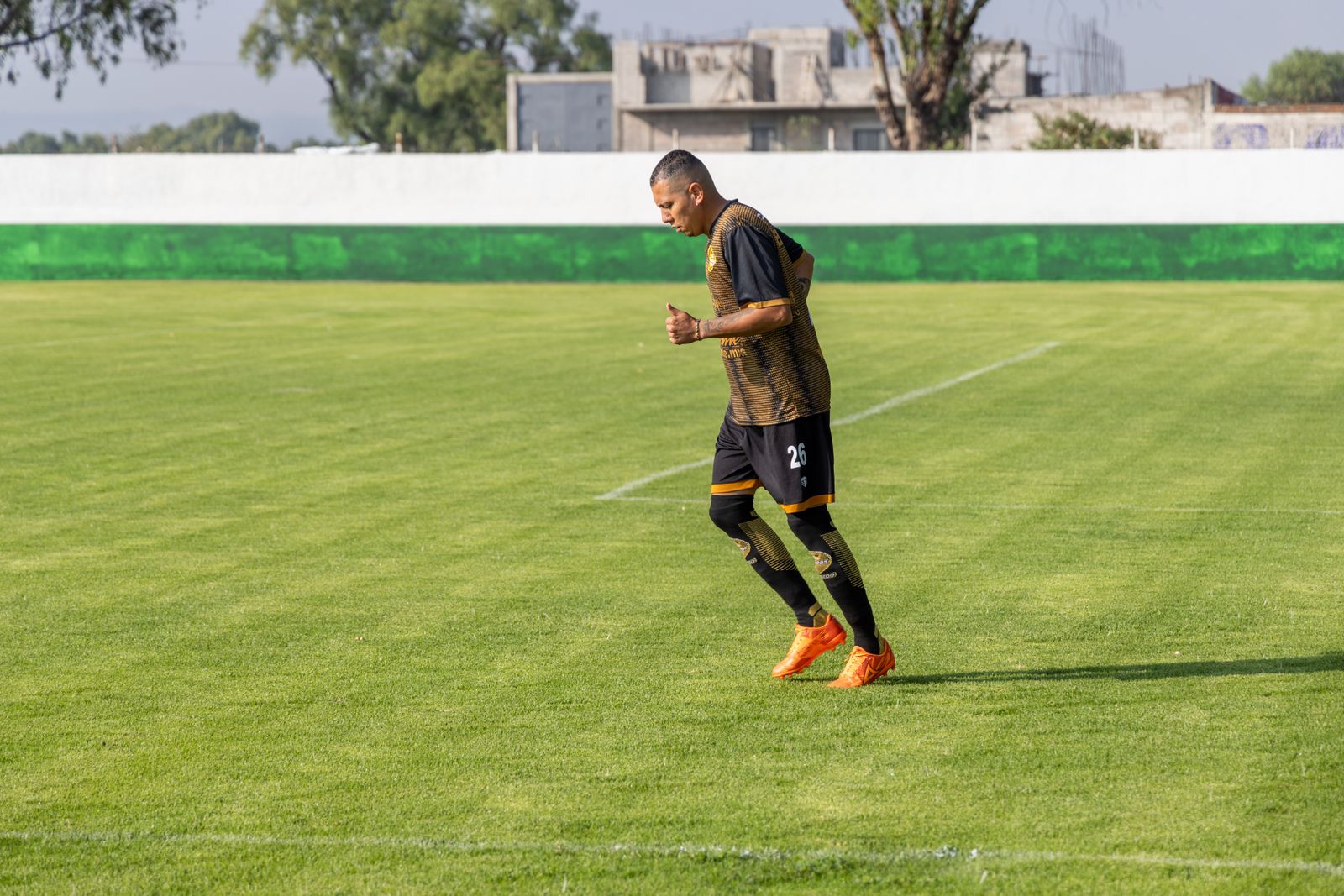 Midfielder walking across the pitch