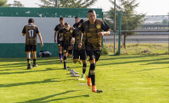 Soccer team warming up on the field, wearing sports uniforms.