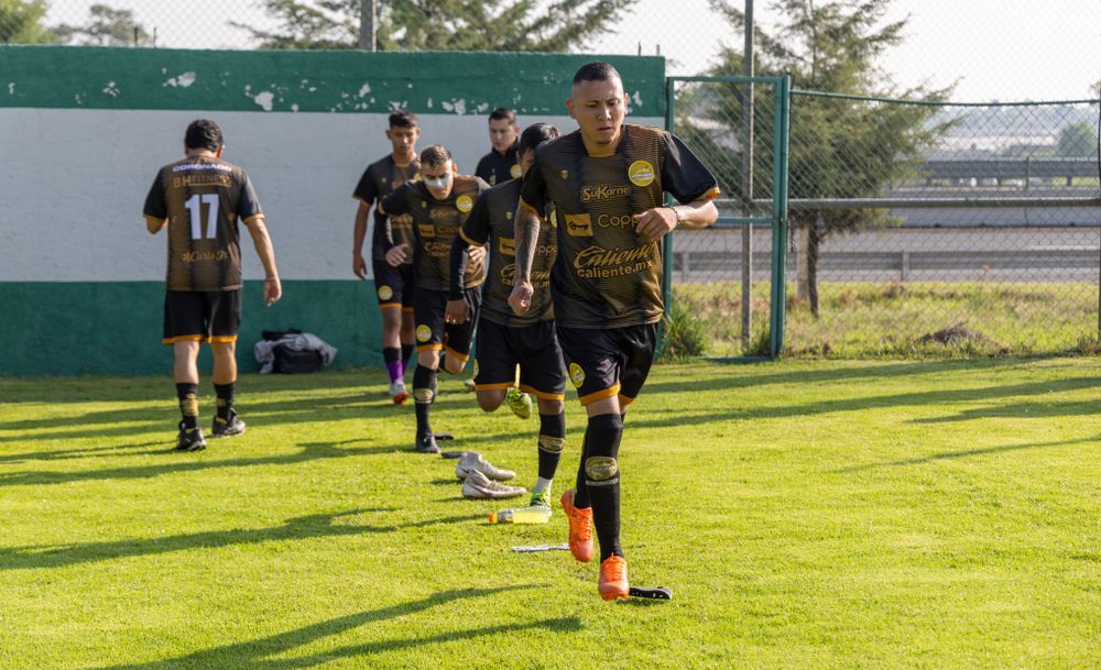 Football team warming up in coordinated sports uniforms before a training session