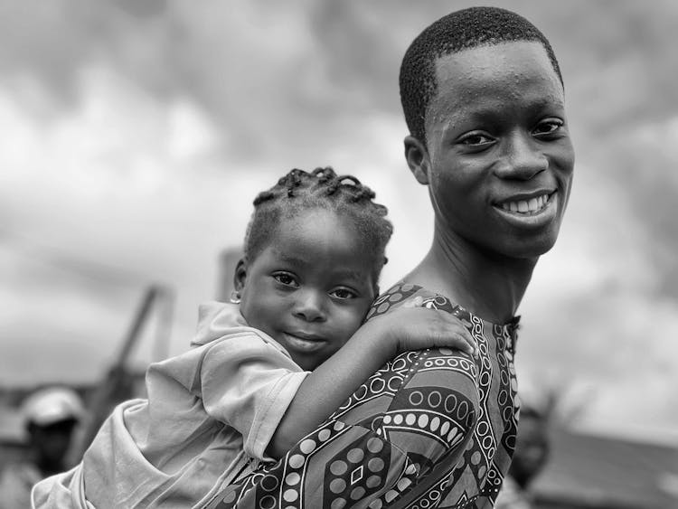 Parent Carrying A Small Child On Back