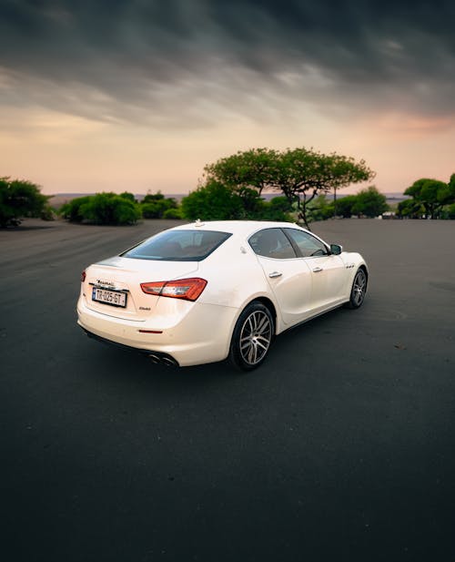 White Maserati Ghibli under Rainy Sky