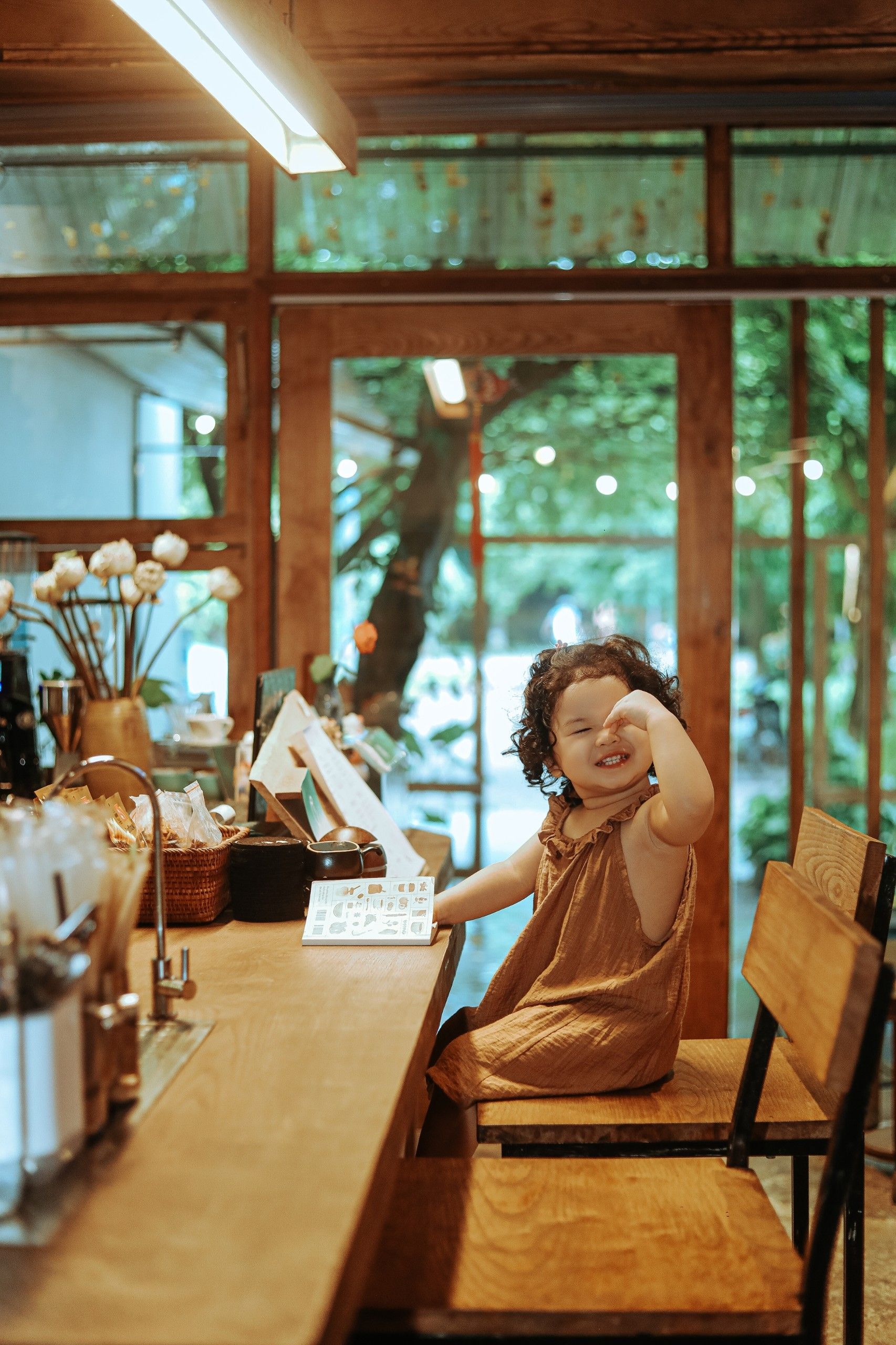 Little Girl Sitting at the Cafe Counter · Free Stock Photo