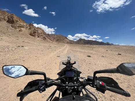 Experience the thrill of off-road biking in a rugged desert landscape with a clear blue sky.