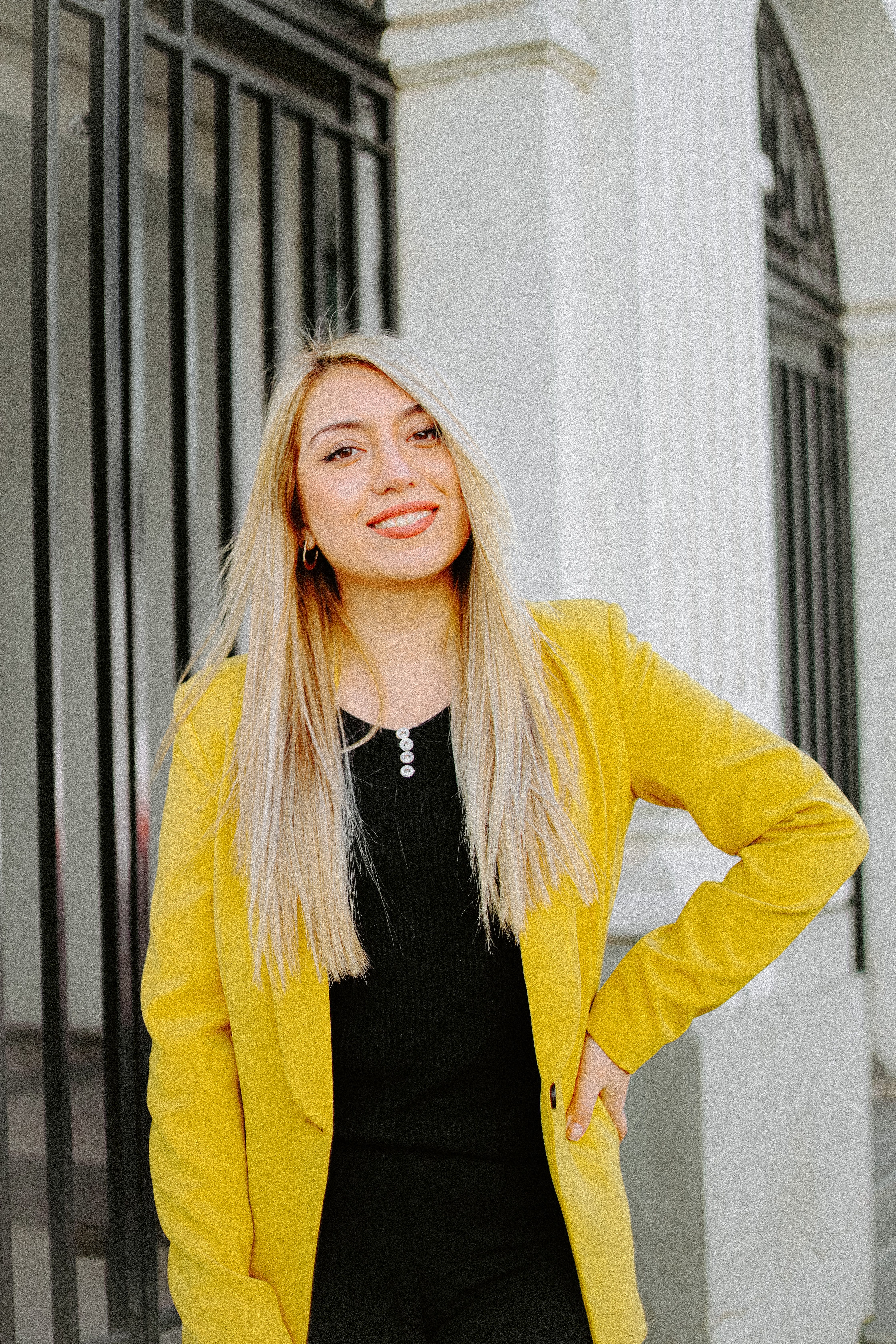 Smiling Woman Wearing a Yellow Jacket · Free Stock Photo