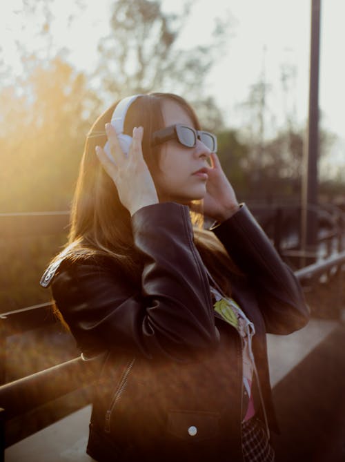 Woman in Headphones and Sunglasses
