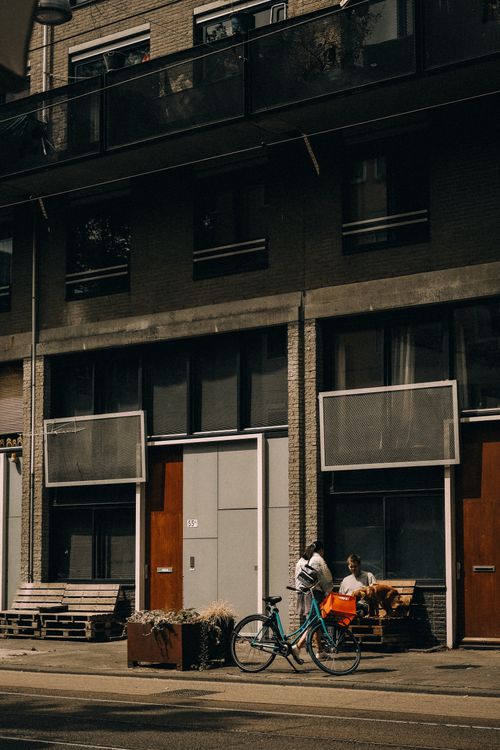 Free A city street scene with a bicycle and two people in an urban setting. Stock Photo