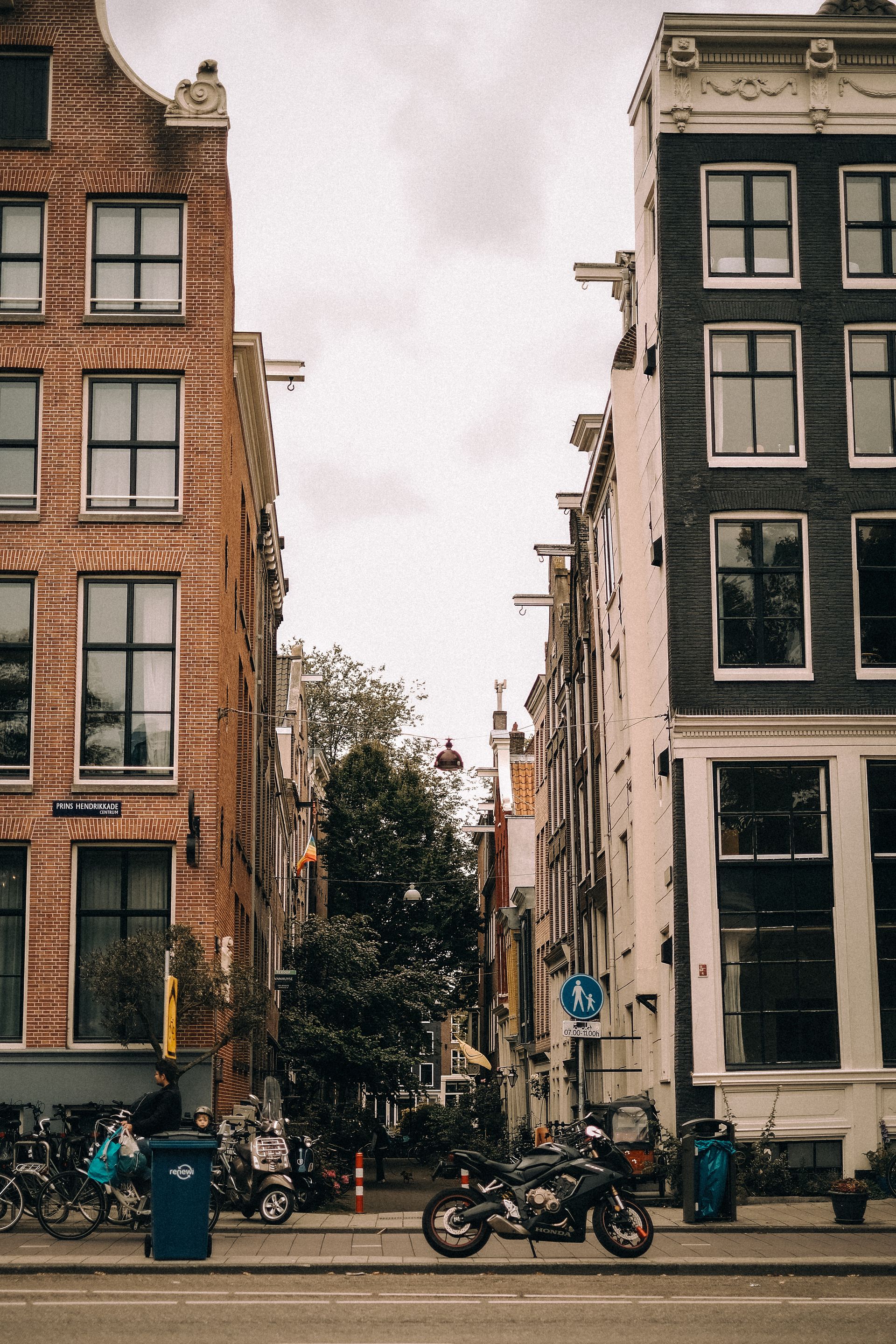 Amsterdam canal street with bicycles and classic Dutch architecture — city identity for ad
